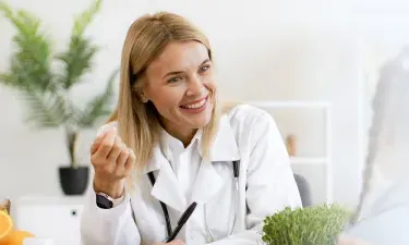 Mississippi family nurse practitioner smiling with pediatric patient during appointment