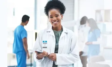 Mississippi DNP nurse executive smiling with patient charts in hospital