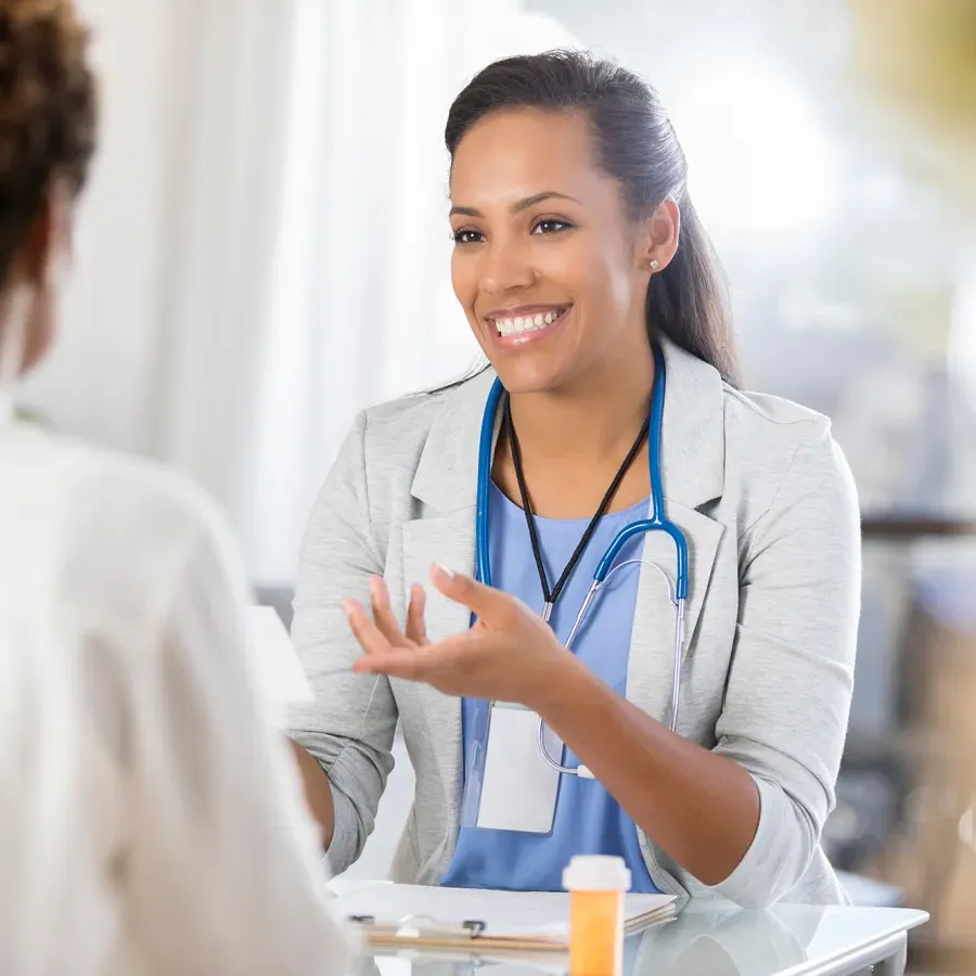 Public Health Nurse with Certificate Speaking with Patient During Appointment